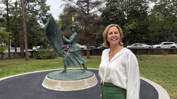 Sculptor Elizabeth O'Kane, standing beside the Spiorad Ban Chiarraí in Tralee