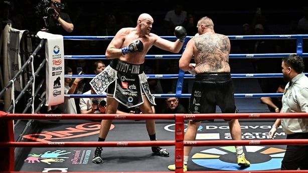 Britain's Tyson Fury (L) trades blows with Poland's Mariusz Wach