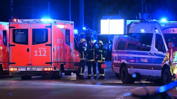 Police and ambulances stand near the scene where one person was killed and around 15 injured after a car is believed to have hit the crowd on the outskirts of the Christopher Street Day (CSD) parade in Berlin, on July 25, 2026. 