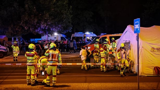 Police and First aid responders are seen at a scene of an attack during CSD pride