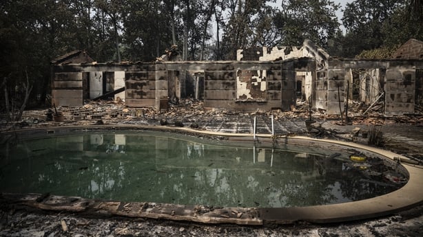 Burnt buildings around a pool in a residential area following a wildfire in Le Porge, in the Gironde Department, south-western France on July 25, 2026