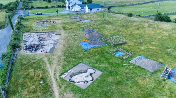 The excavation site at Prospecthill, Co Galway, with the portal tomb capstone in the foreground and the outline of the court tomb behind