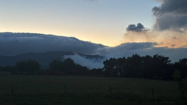 Smoke over a dark scene of the Comeragh Mountains