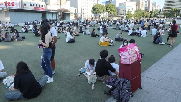 People wait in a park after evacuating buildings following a strong earthquake in Kumamoto City 