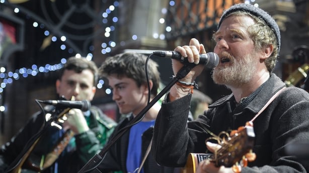Glen Hansard (Right) takes part in the annual Christmas Eve busk in aid of the Dublin Simon Community outside the Gaiety Theater in Dublin