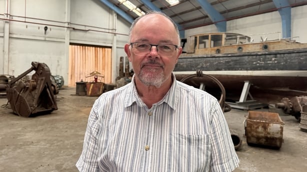 Anthony Flynn standing in front of a shipyard shed