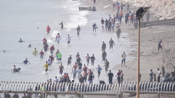 Several migrants are attempting to swim across the border on 30 July 2026 in Ceuta, Spain. Hundreds of people of Maghreb origin have crossed into Ceuta from Morocco this morning, either by swimming or via the breakwater, and a crowd is waiting on the other side of the border to enter the autonomous