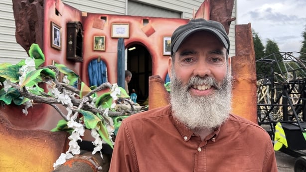 Nicholas Kavanagh standing in front of a parade float.