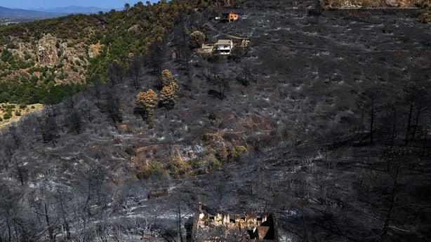 This aerial photo taken with a drone shows a burnt-out house in the Iruelas Valley surrounded by scorched ground following a devastating wildfire, near El Tiemblo, 80 kilometres west of Madrid