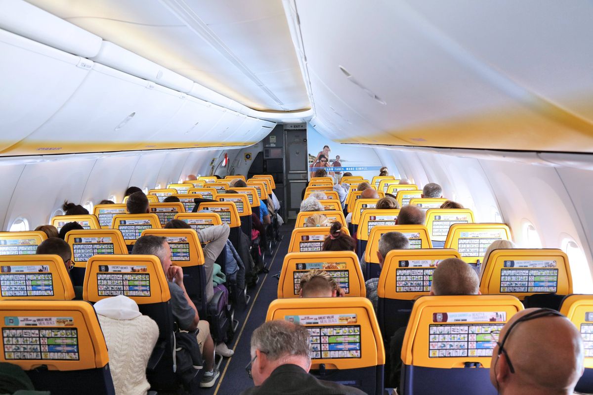 Inside Ryanair flight cabin, people in their seats