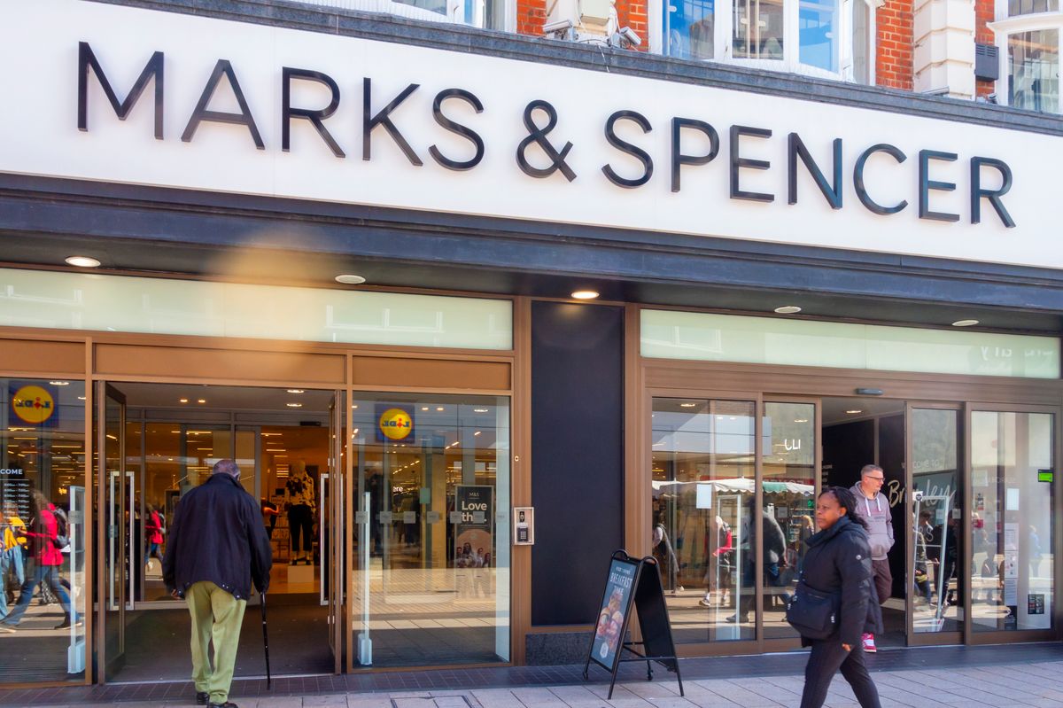 Customers entering and leaving a branch of the British chain of department stores Marks & Spencer