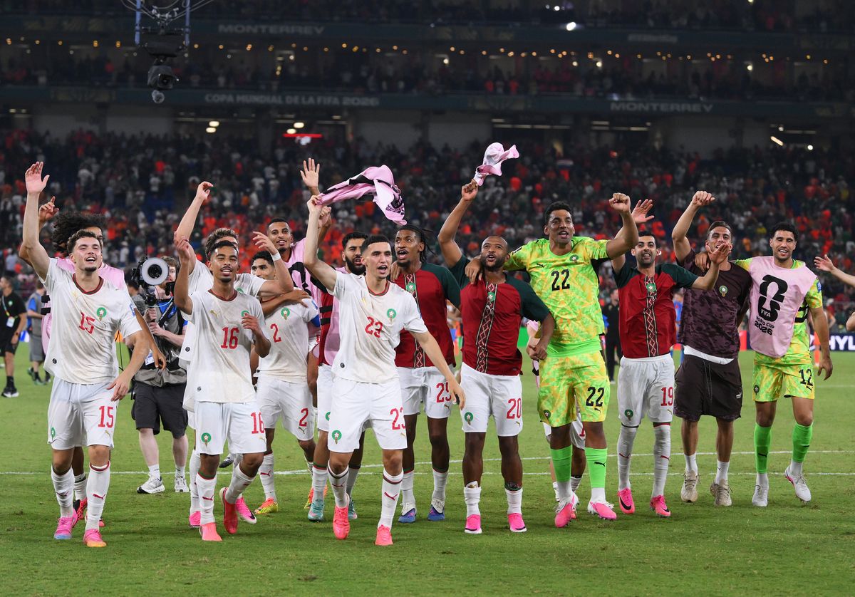 Morocco's players celebrate after qualifying for the last 16