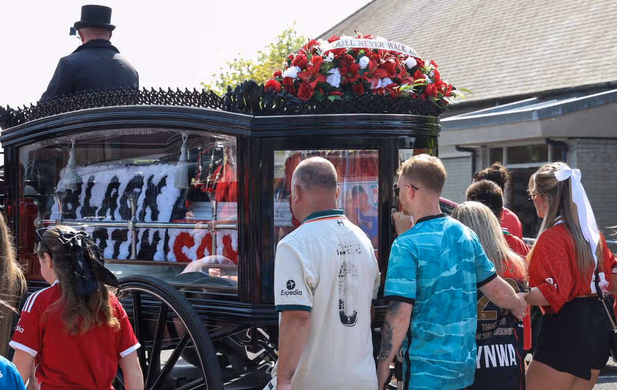 The cortege arrives at church led by a piper