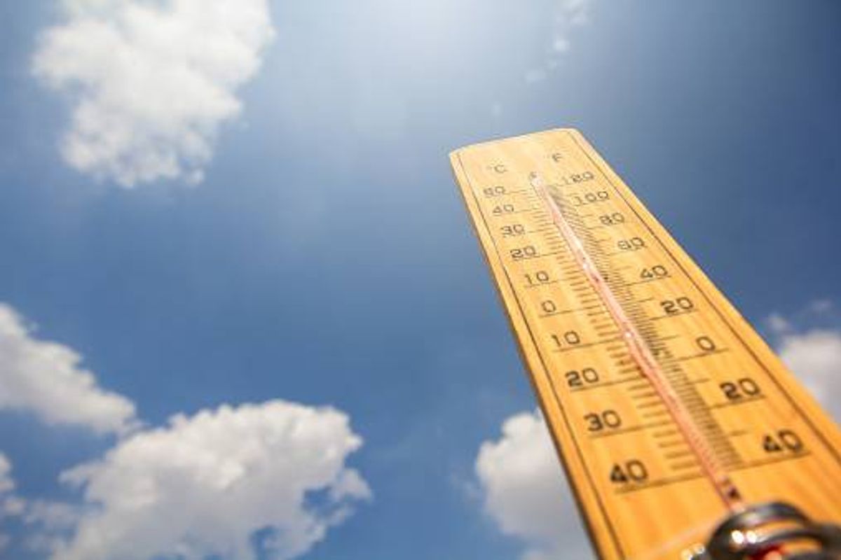 A thermometer against a blue sky