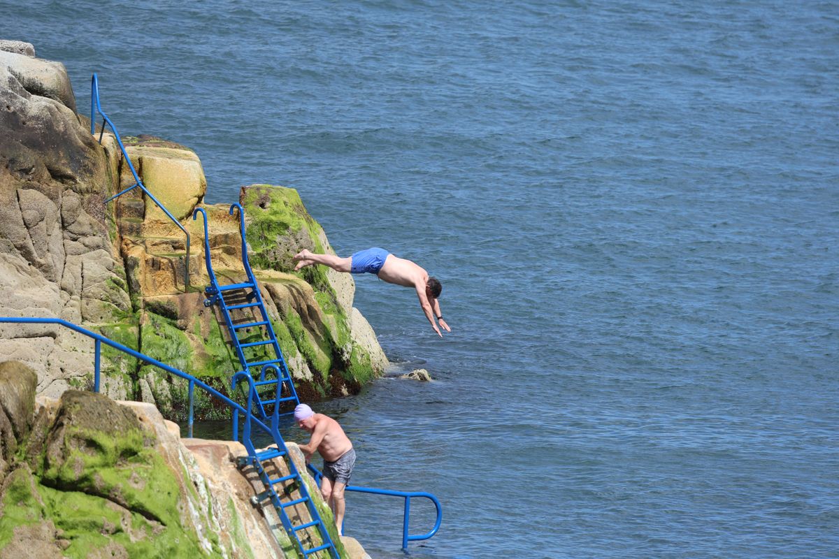 People enjoying the sunny weather at the Forty Foot in Sandycove, County Dublin.