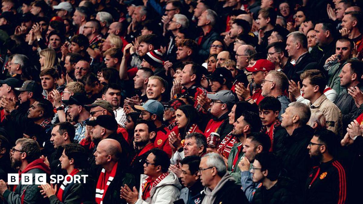 Manchester United fans applaud before kick off of a Premier League fixture against Liverpool
