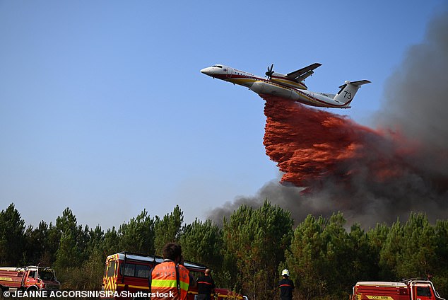 More than 2,200 firefighters are battling the French fires, with 20 aircraft providing support to tamp down the flames; a plane dropping fire retardant is pictured on Wednesday near Gironde
