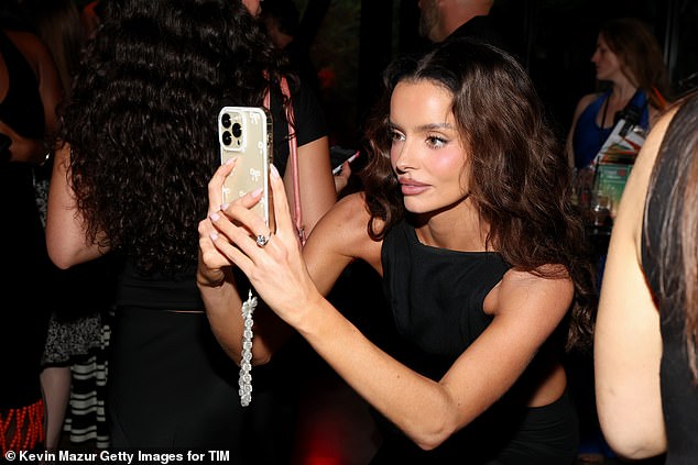 The star was seen snapping photos throughout the night