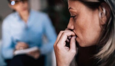 Woman with anxiety talking to mental health professional.