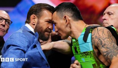 Conor McGregor and Max Holloway stand with their foreheads pressed against each other at a news conference before UFC 329
