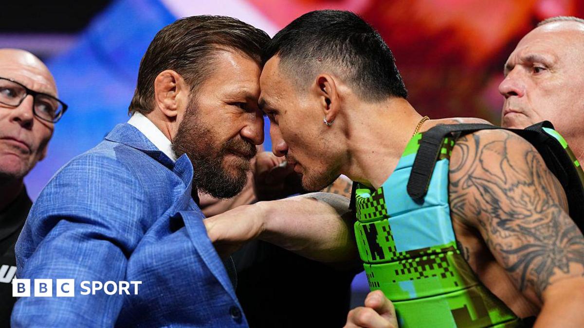 Conor McGregor and Max Holloway stand with their foreheads pressed against each other at a news conference before UFC 329