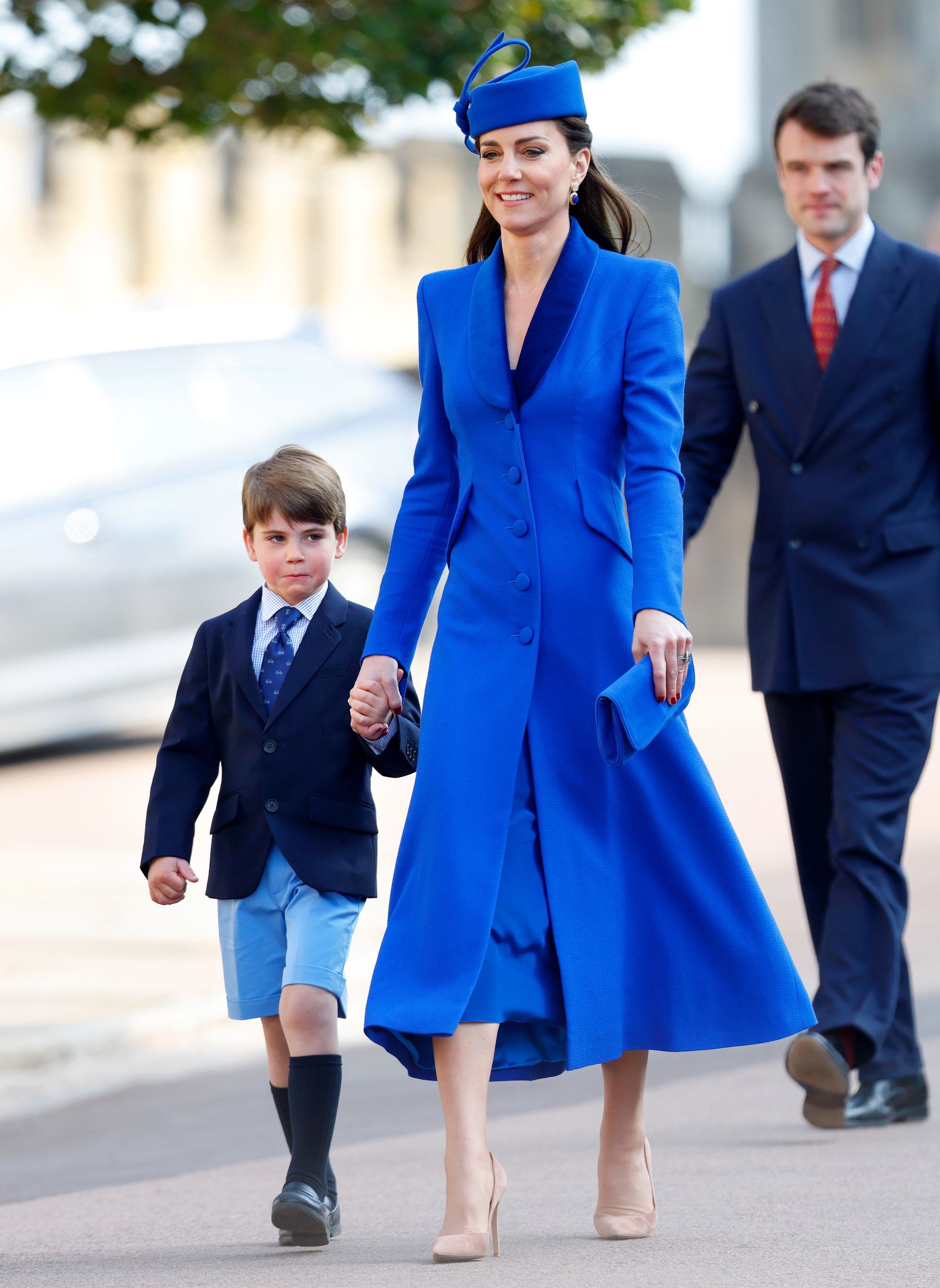 Image may contain Person Walking People Clothing Coat Adult Child Overcoat and Shorts