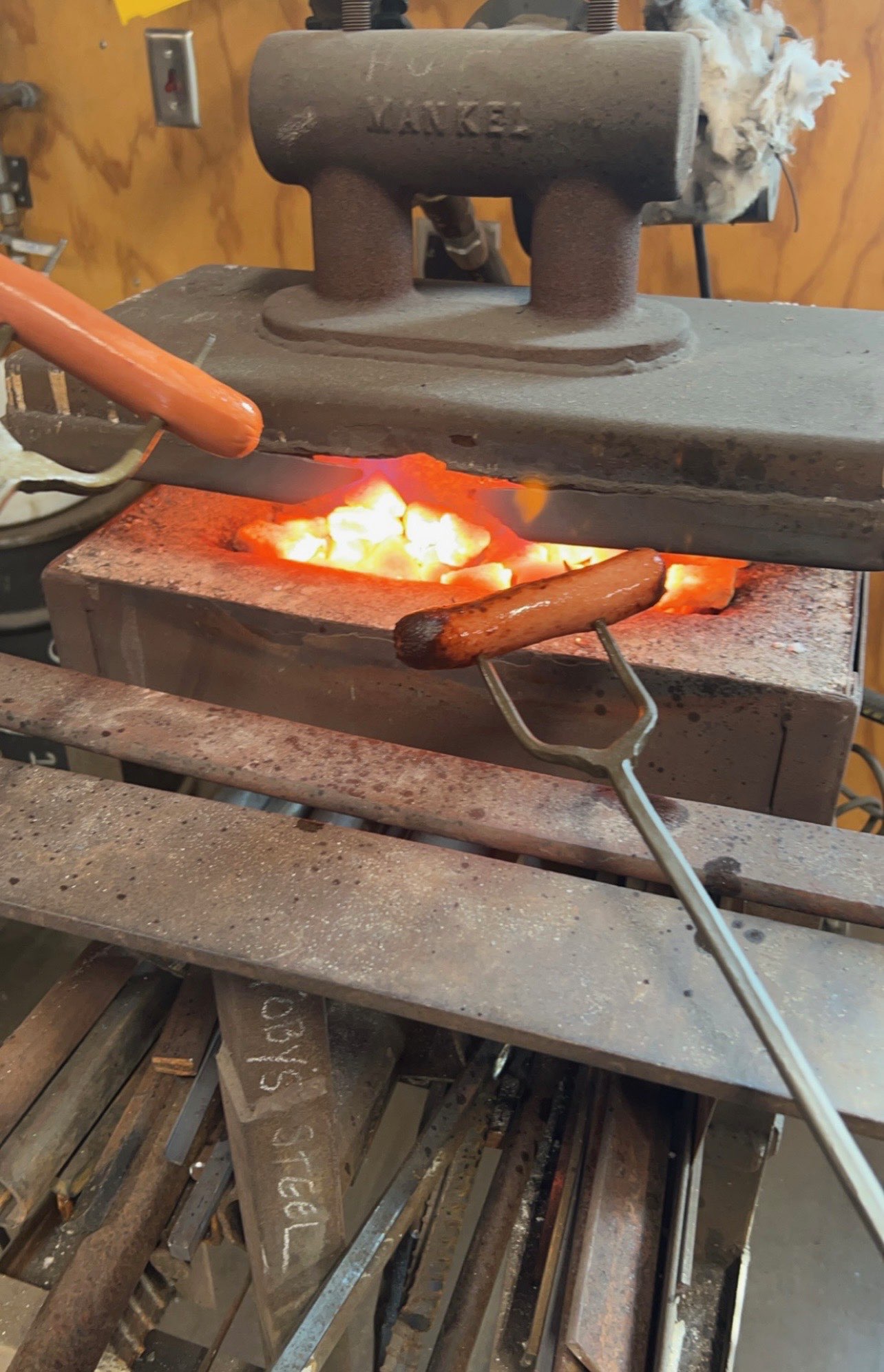 Schluckebier in the foundry environment, highlighting the blend of experimentation and creativeness by grilling hot dogs. Courtesy photo. <br>