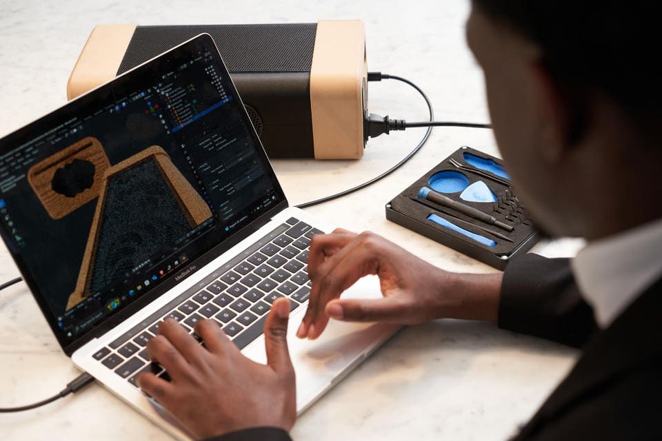 Young man using laptop to design