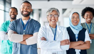 Portrait, confidence and team of doctors in the hospital standing after a consultation or surgery. Success, healthcare and group of professional medical workers in collaboration at a medicare clinic.