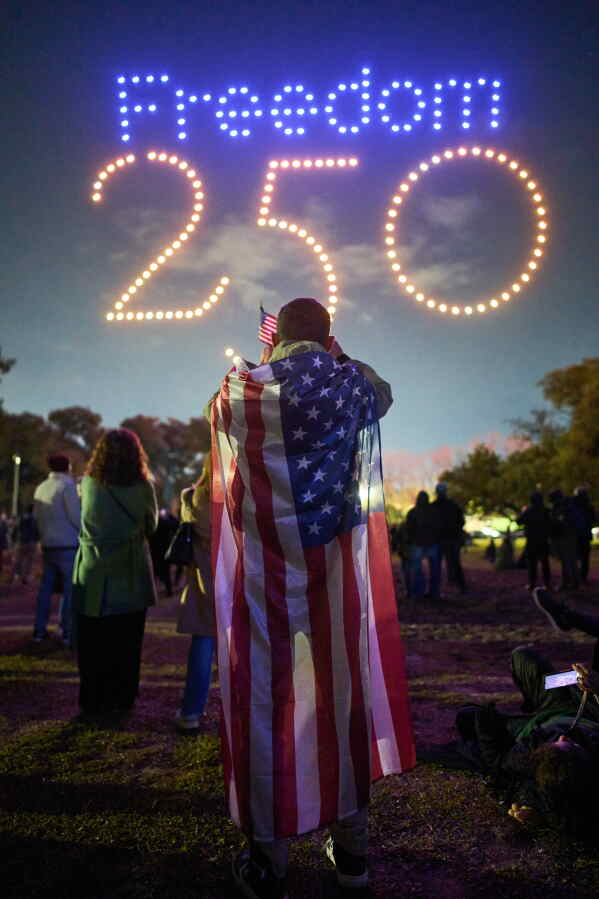 Leandro Braga watches a drone exhibition at celebrations marking the 250th anniversary of U.S. independence in Buenos Aires, Argentina, Saturday, July 4, 2026. (AP Photo/Rodrigo Abd)