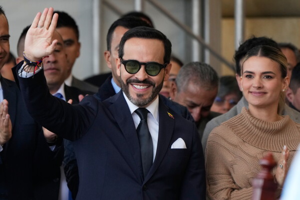 Colombian President-elect Abelardo de la Espriella, left, waves to supporters next to his wife Ana Lucia Pineda during a Mass in honor of Our Lady of the Rosary of Chiquinquira, in Chiquinquira, Colombia, July 9, 2026. (AP Photo/Fernando Vergara, File)