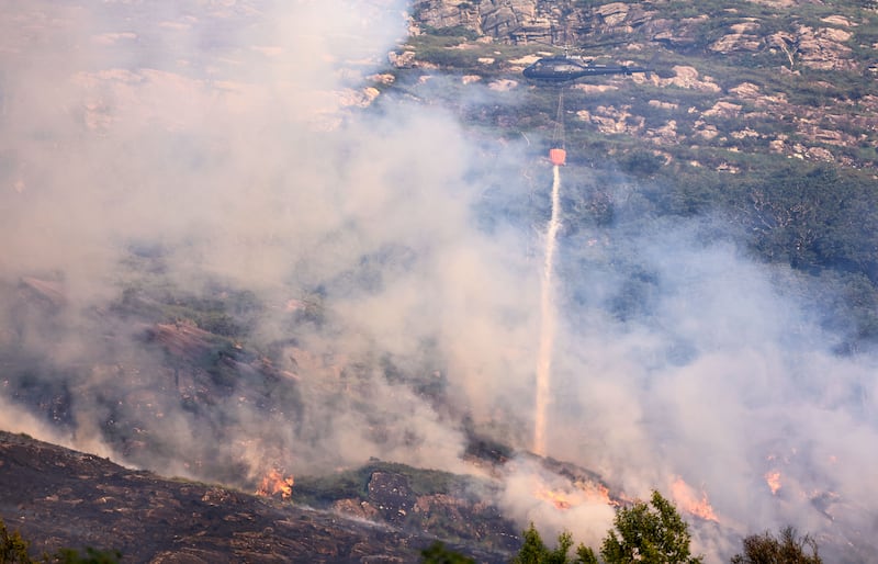 An Air Corps helicopter drops water on a wildfire that broke out in the Five Mile Bridge area of Killarney National Park on Tuesday evening. Photograph: Valerie O'Sullivan/NPWS