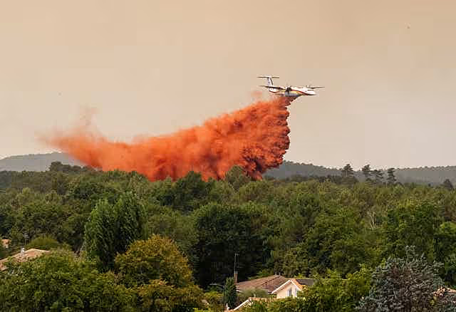 A water bomber plane drops water