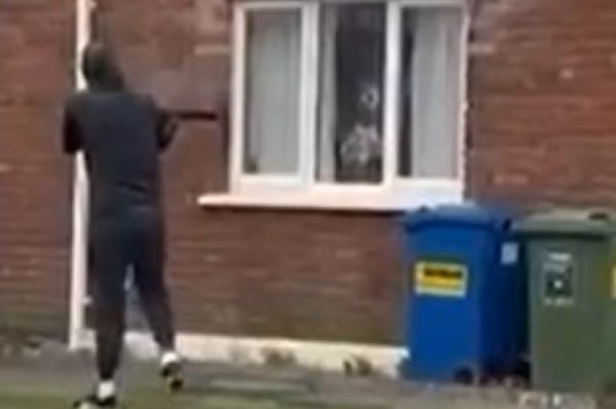 The gunman is caught on camera as he shoots at the house