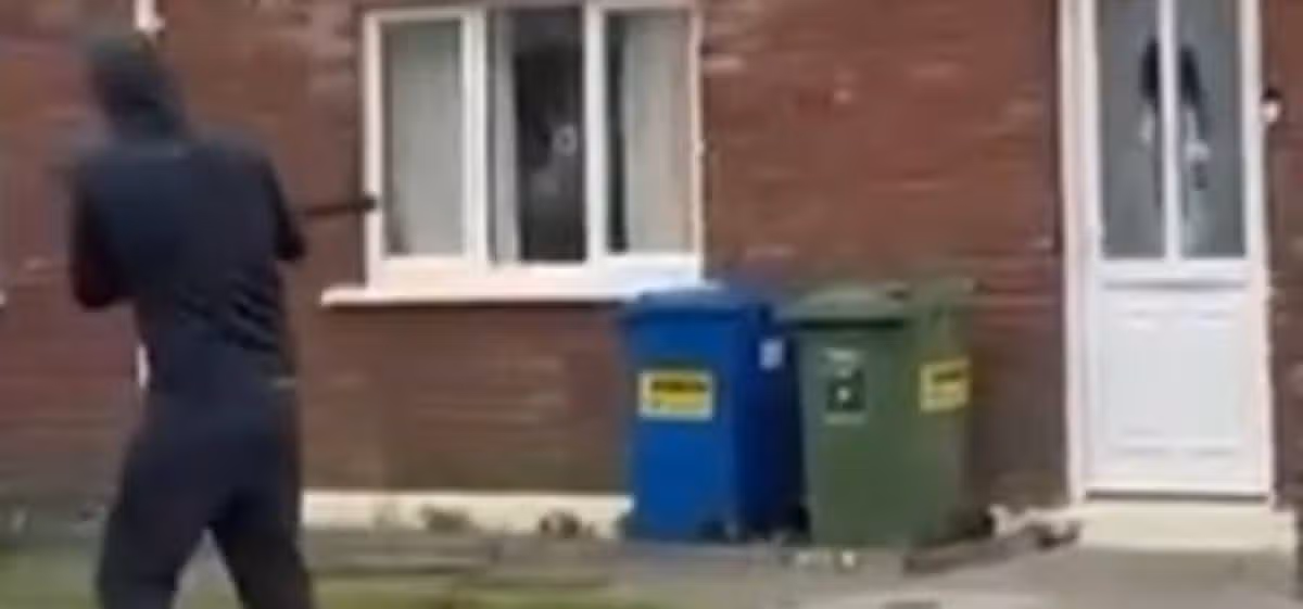 The gunman was filmed firing a total of four shots at the property in the early morning attack