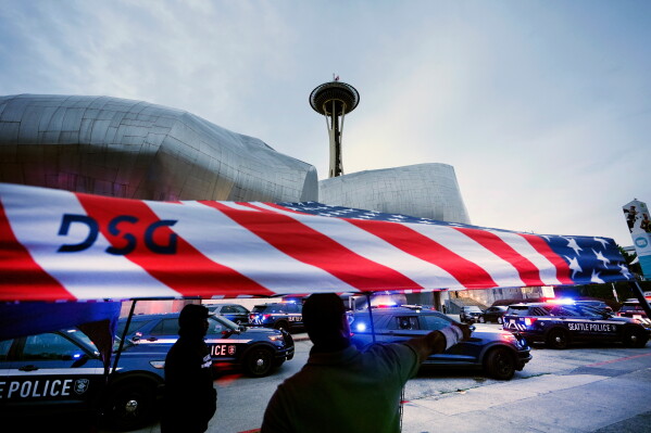 Police respond to a shooting at Seattle Center during the Bite of Seattle food festival Sunday, July 26, 2026, in Seattle, Wash. (AP Photo/Lindsey Wasson)
