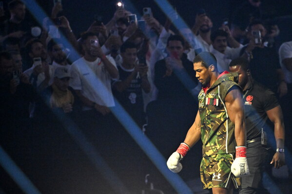 Britain's Anthony Joshua arrives for the heavyweight title fight with Albania's Kristian Prenga in Jeddah, Saudi Arabia, Sunday, July 26, 2026. (AP Photo/Ali Issa)