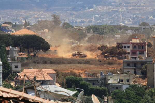 An Israeli tank drives through Zawtar al-Sharqiyah village, occupied by Israeli forces, as seen from the southern village of Zawtar al-Gharbieh, Lebanon, Monday, July 27, 2026. (AP Photo/Mustafa Jamalddine)