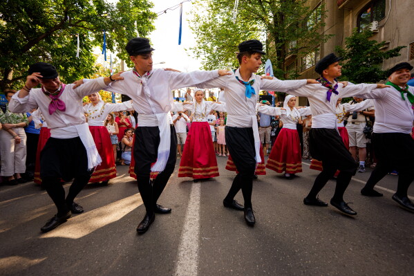 The Kymata ensemble dances during the Kalimera Festival, an event promoting Greek culture, in Bucharest, Romania, Saturday, July 25, 2026. (AP Photo/Andreea Alexandru)