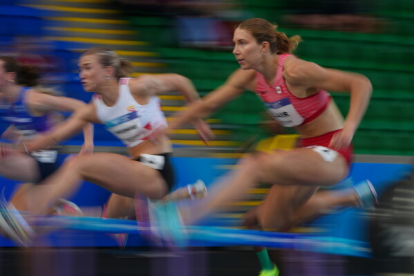 Canada's Hannah Blair, right, and Jersey's Lucy Woodward compete in the Women's Heptathlon 100m hurdles at the Commonwealth Games in Glasgow, Scotland, Tuesday, July 28, 2026. (AP Photo/Alastair Grant)