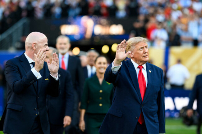 rutherford-united-states-19-july-2026-u-s-president-donald-trump-right-waves-as-he-and-fifa-president-gianni-infantino-left-walk-out-on-the-pitch-to-present-the-trophy-during-the-world-cup-fi