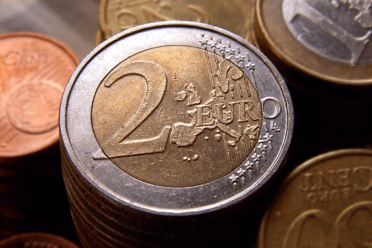 Two Euro coin in front of other coins