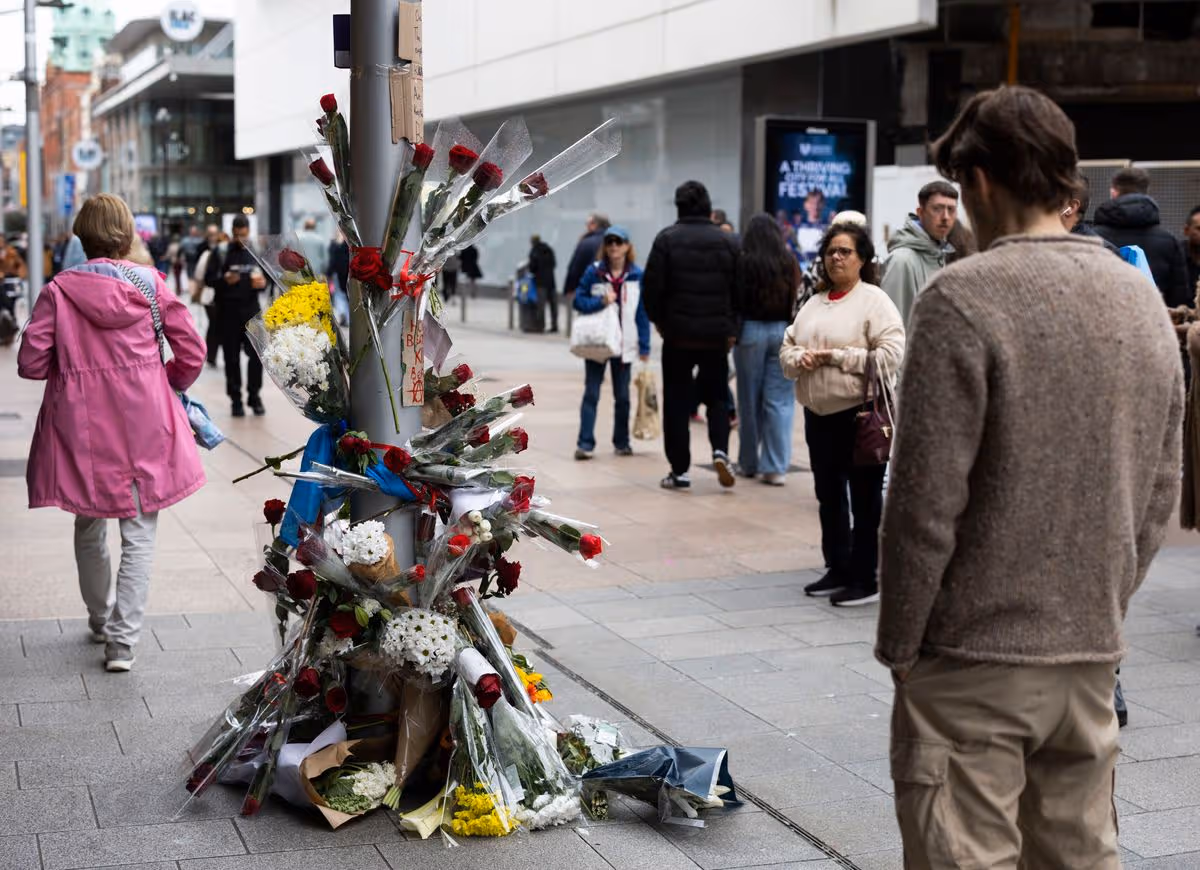 Flowers left at the scene on Henry street where Yves Sakila was restrained and later died.