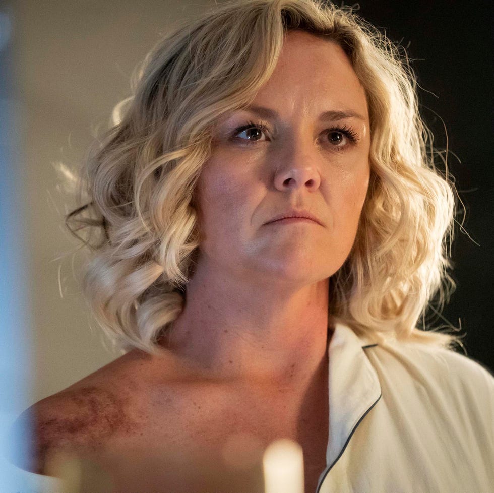 person with short blonde curly hair looking serious. person with short blonde curly hair looking serious.