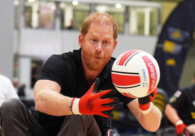 Harry catching the ball while playing a game of wheelchair rugby