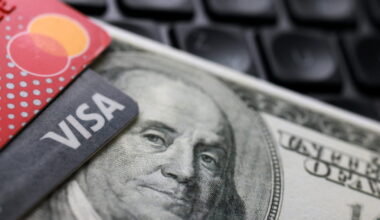 Illustration shows a U.S. dollar banknote, Visa and Mastercard cards
