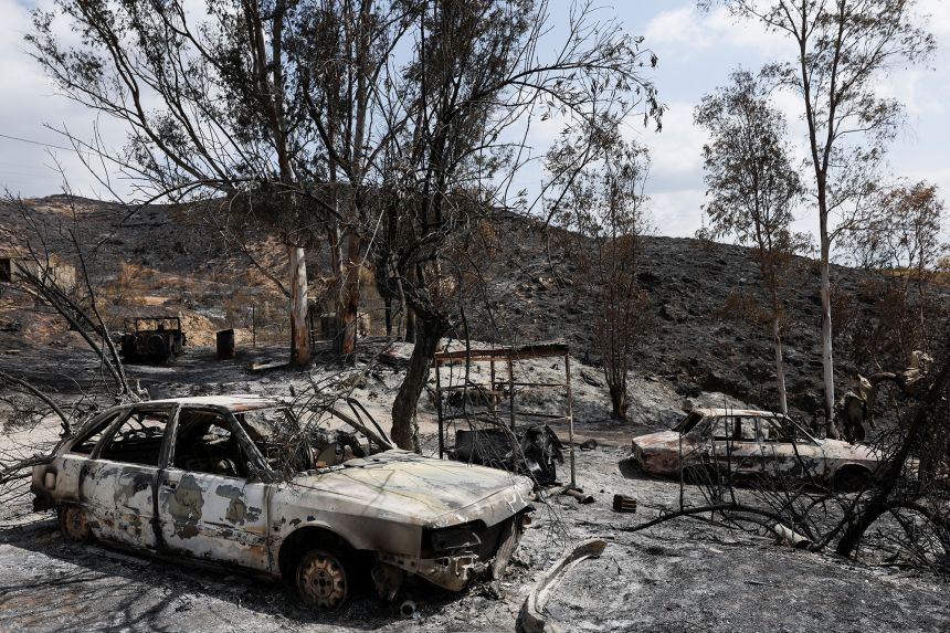 The charred remains of vehicles after a deadly fire swept through Almeria province in Spain, on Sunday.
