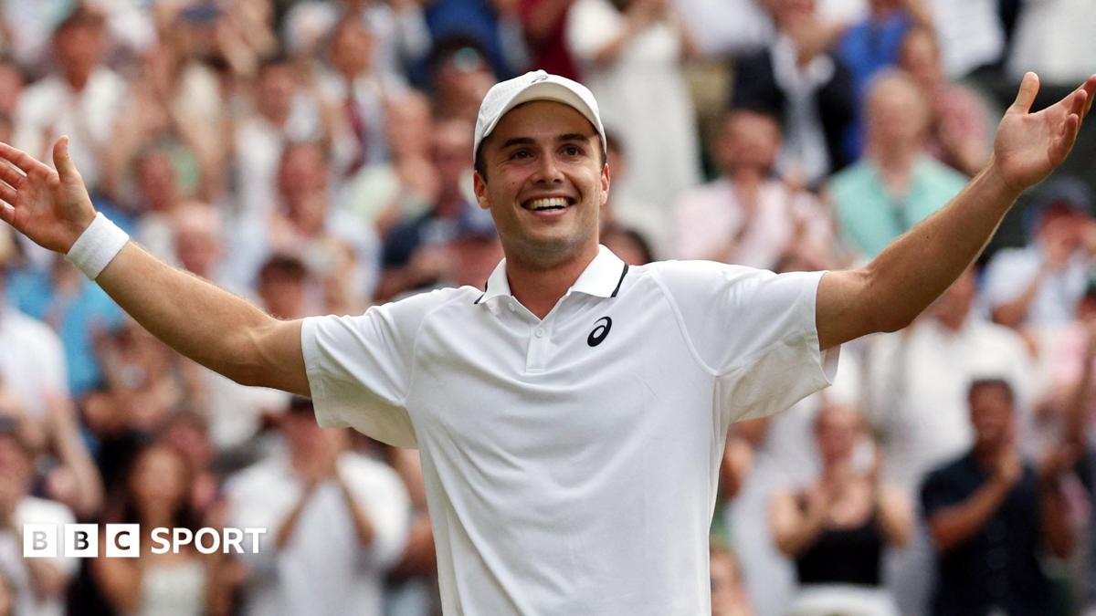 Flavio Cobolli applauds the Wimbledon crowd after his win over Alex de Minaur