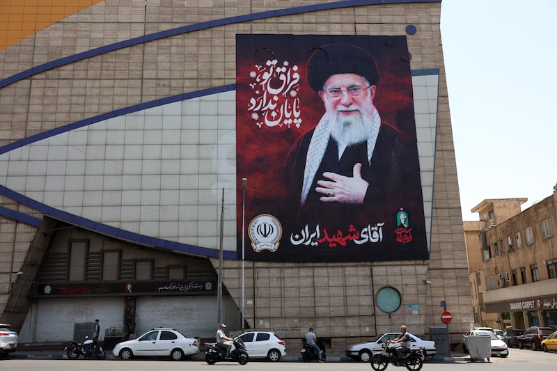 Iranians drive past a billboard of late Iranian supreme leader Ayatollah Ali Khamenei in a street in Tehran, Iran on Thursday. Photograph: Abedin Taherkenareh/EPA