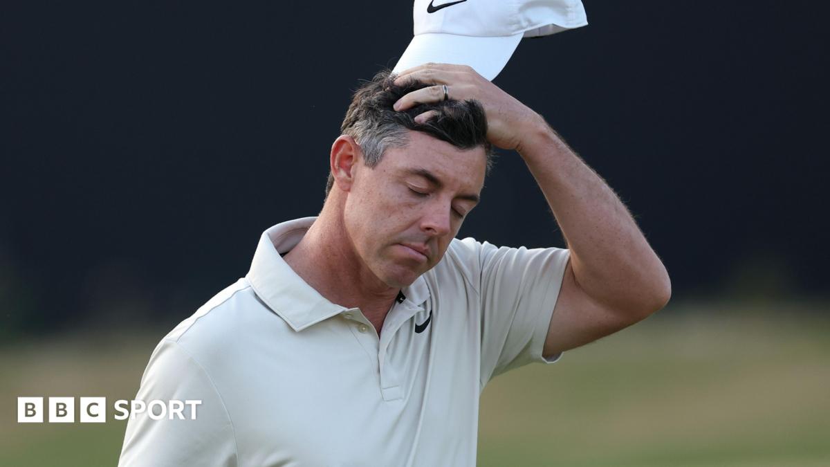 Rory McIlroy cuts a dejected figure as he walks off the 18th green